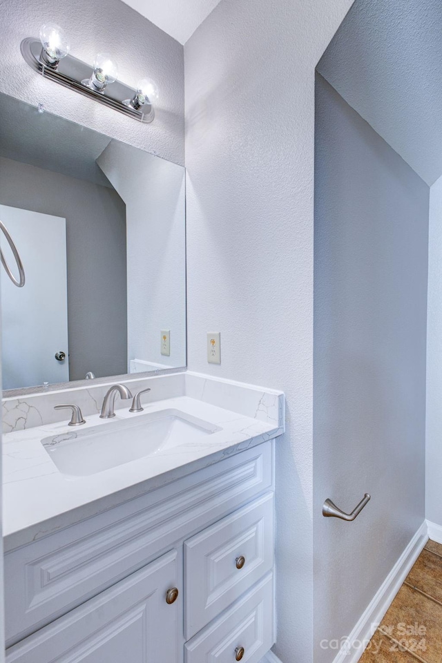 bathroom featuring tile patterned flooring and vanity