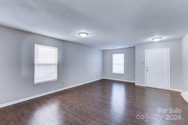 spare room featuring dark wood-type flooring