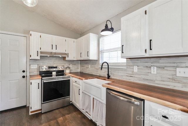 kitchen featuring white cabinetry, appliances with stainless steel finishes, and butcher block counters