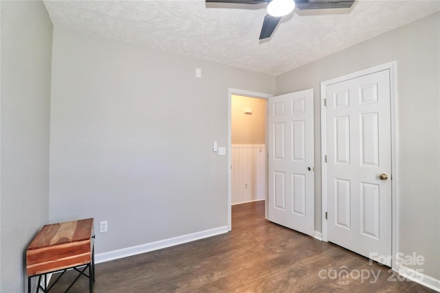 bedroom featuring a textured ceiling, ceiling fan, wood finished floors, and baseboards