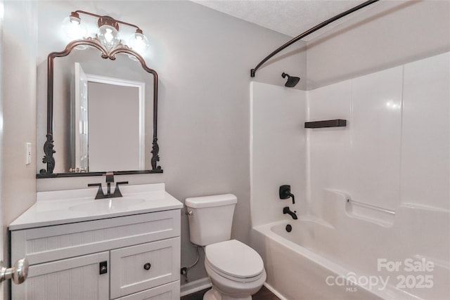 bathroom with washtub / shower combination, vanity, and toilet