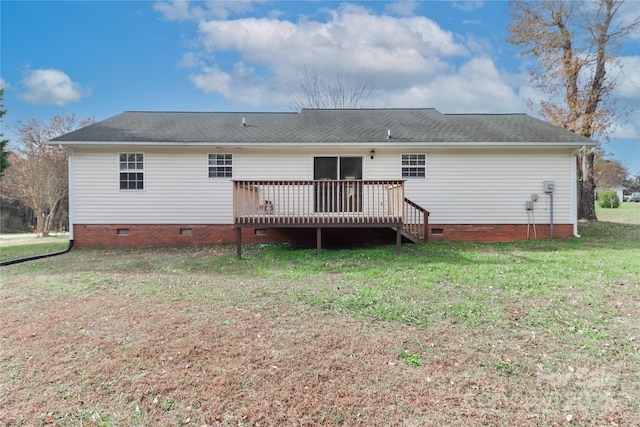 rear view of property featuring crawl space, a wooden deck, and a lawn