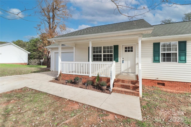 bungalow-style home featuring covered porch, concrete driveway, a shingled roof, and crawl space