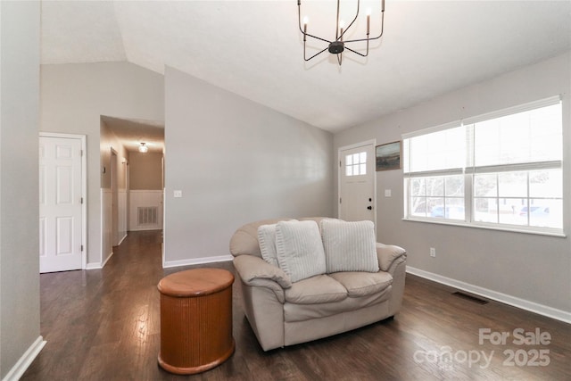 living area featuring dark wood-type flooring, visible vents, vaulted ceiling, and baseboards