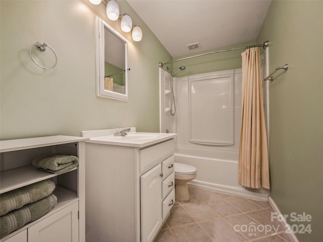 full bathroom with tile patterned floors, shower / tub combo with curtain, vanity, and toilet