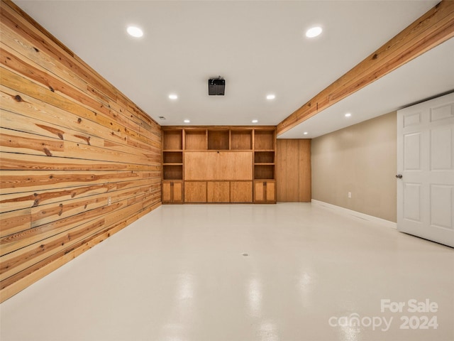 basement featuring wood walls