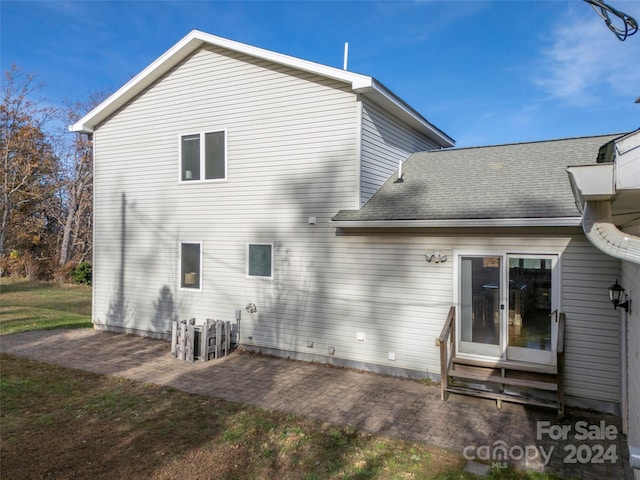 back of property with a patio