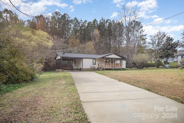 view of front of house with a front lawn, a porch, and a carport