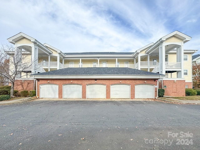 view of front of home with a garage and a balcony