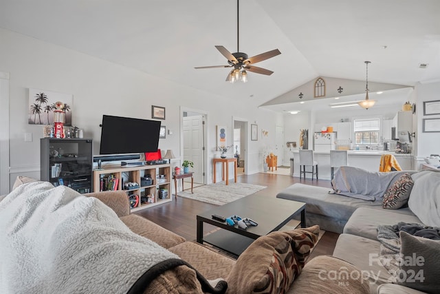 living room featuring ceiling fan, lofted ceiling, and hardwood / wood-style flooring