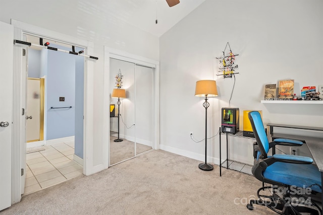 carpeted office with ceiling fan and vaulted ceiling