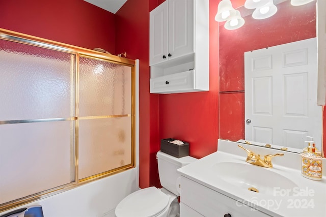 full bathroom with vanity, toilet, and shower / bath combination with glass door