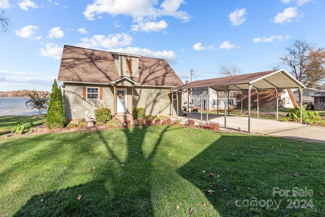 view of front facade featuring a water view, a front yard, and a carport