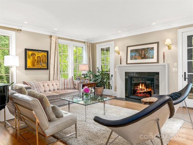 living room with plenty of natural light, ornamental molding, and a fireplace