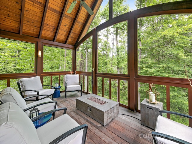 unfurnished sunroom with wooden ceiling, a wealth of natural light, vaulted ceiling with beams, and ceiling fan