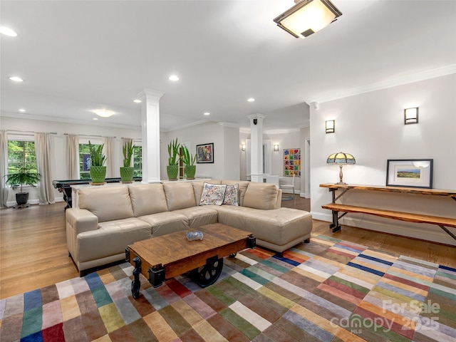 living room featuring pool table, ornamental molding, ornate columns, and light hardwood / wood-style flooring