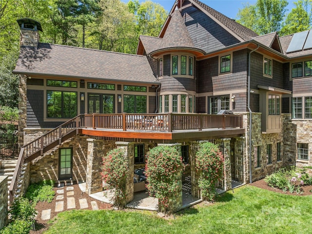 back of property featuring a lawn and a deck