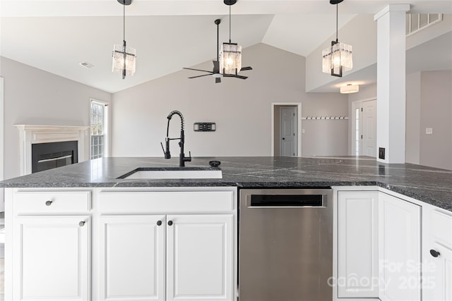 kitchen with visible vents, lofted ceiling, a fireplace, a sink, and open floor plan