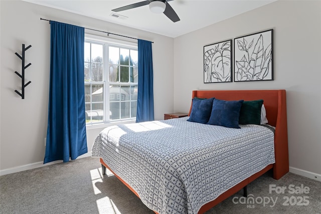 bedroom featuring visible vents, a ceiling fan, baseboards, and carpet floors