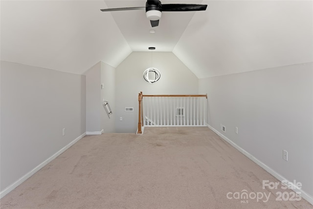 bonus room featuring a ceiling fan, visible vents, baseboards, vaulted ceiling, and carpet flooring