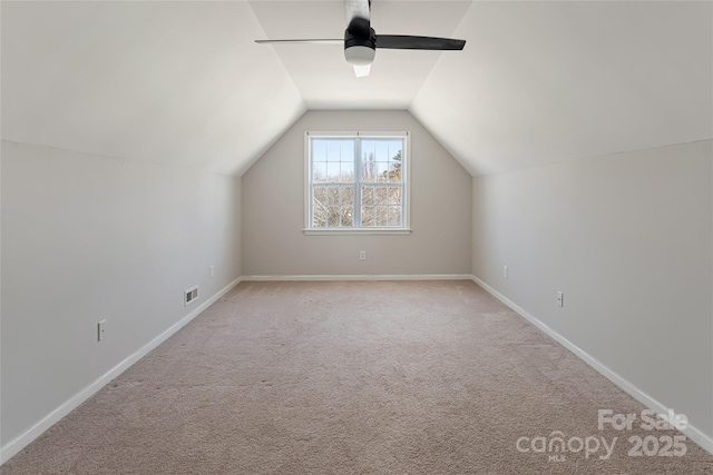 additional living space with visible vents, baseboards, carpet flooring, lofted ceiling, and ceiling fan