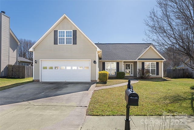 traditional home with a front yard, concrete driveway, fence, and a shingled roof