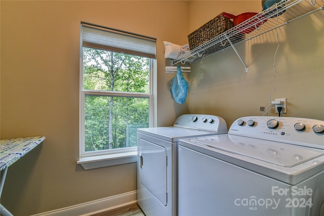 washroom with washer and dryer, hardwood / wood-style floors, and a healthy amount of sunlight