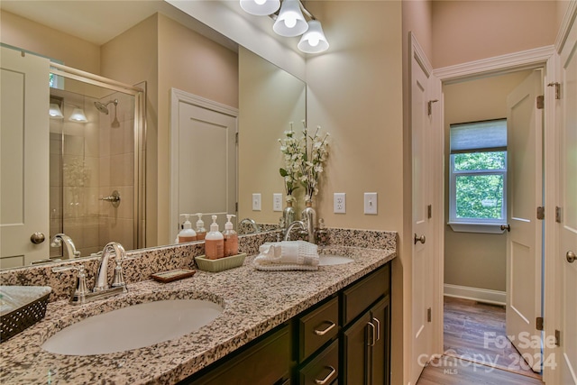 bathroom featuring hardwood / wood-style floors, vanity, and walk in shower