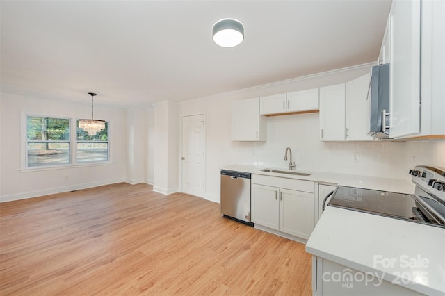 kitchen with pendant lighting, dishwasher, range with electric cooktop, sink, and white cabinetry