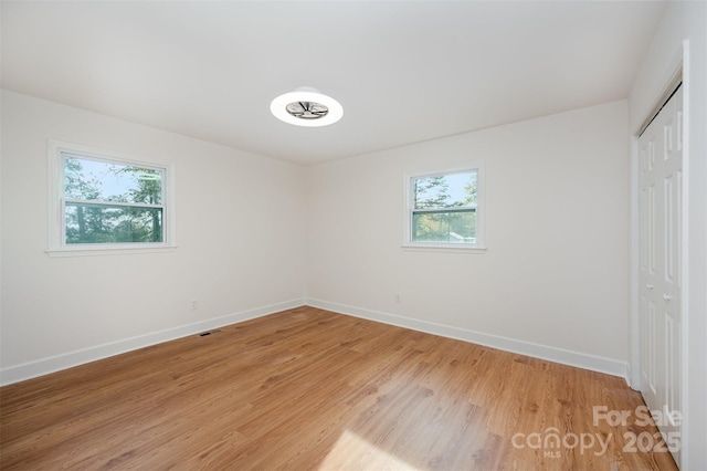 spare room with hardwood / wood-style floors