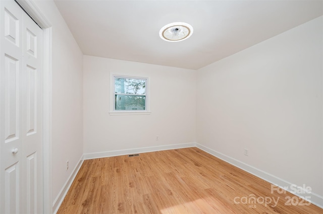 spare room with light hardwood / wood-style flooring