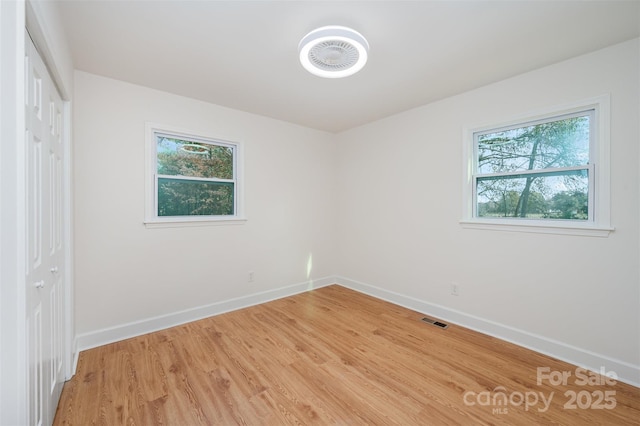 unfurnished room with wood-type flooring