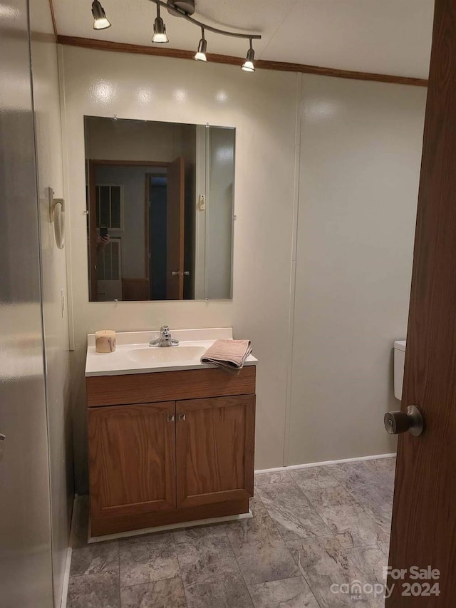 bathroom with vanity and crown molding