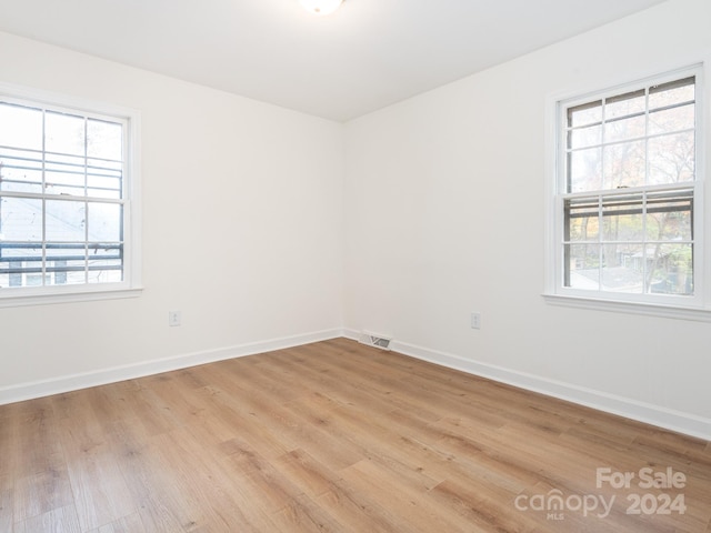 unfurnished room with light hardwood / wood-style flooring