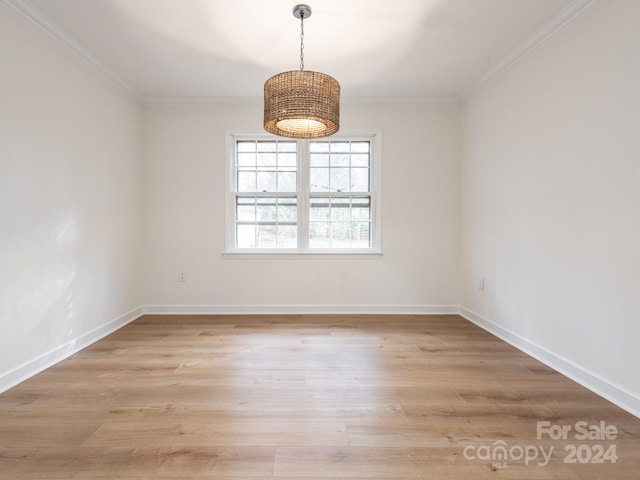 unfurnished room with light hardwood / wood-style flooring and crown molding