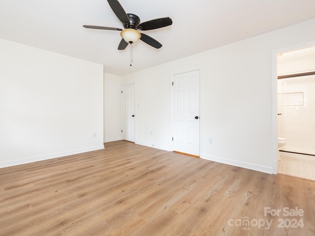 unfurnished bedroom with light hardwood / wood-style flooring, ensuite bath, and ceiling fan