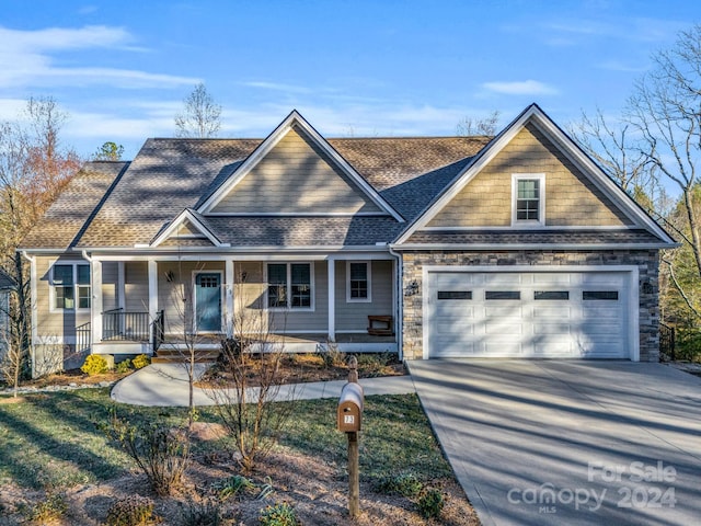 view of front of home featuring covered porch and a garage