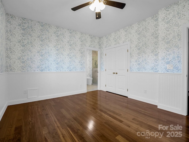 unfurnished room featuring ceiling fan and dark hardwood / wood-style flooring