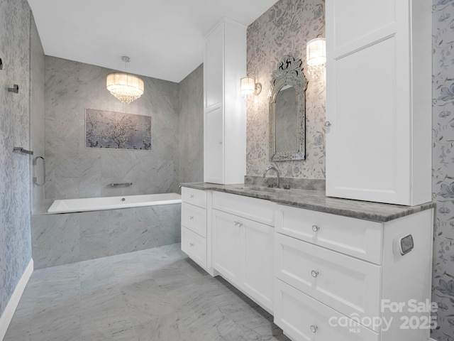 bathroom with vanity and tiled tub