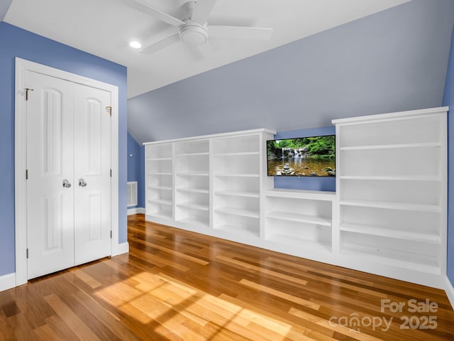 interior space with lofted ceiling, wood-type flooring, and ceiling fan