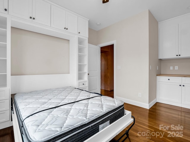 bedroom with dark hardwood / wood-style flooring