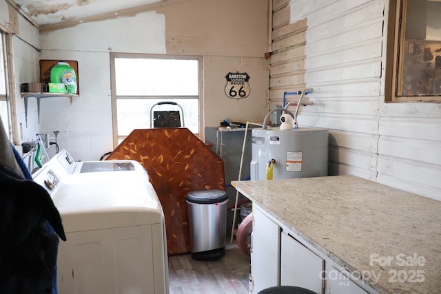 laundry room featuring washing machine and clothes dryer and water heater