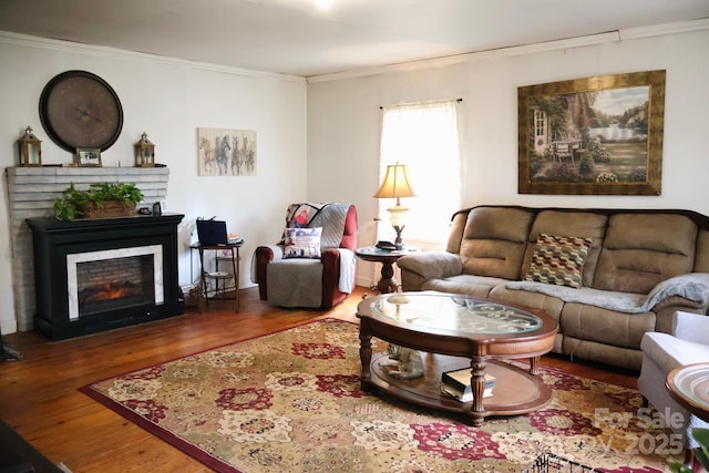 living room featuring hardwood / wood-style flooring and ornamental molding