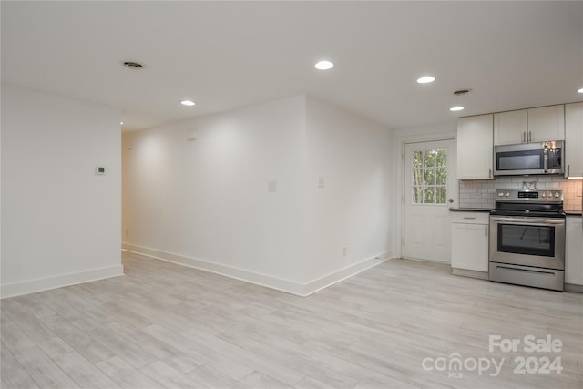 kitchen featuring tasteful backsplash, light hardwood / wood-style flooring, and stainless steel appliances