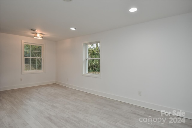 empty room with light hardwood / wood-style flooring