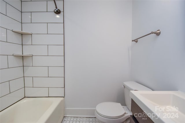 full bathroom featuring vanity, tile patterned flooring, tiled shower / bath, and toilet