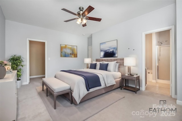 carpeted bedroom with ceiling fan and ensuite bath