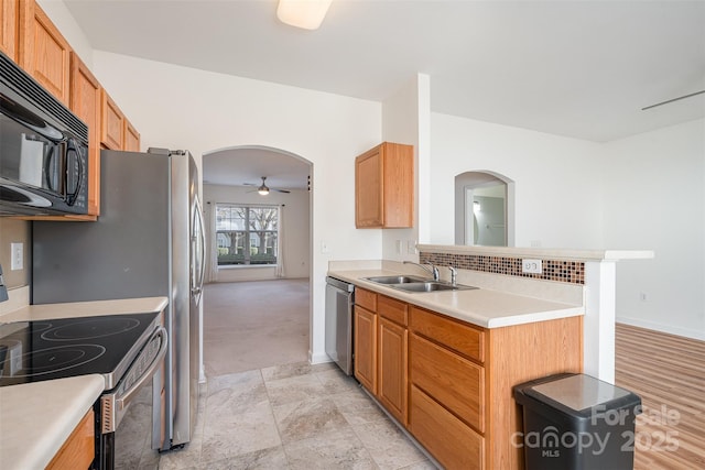 kitchen with electric range, dishwasher, sink, ceiling fan, and kitchen peninsula