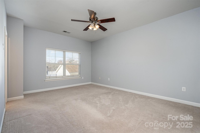 spare room with ceiling fan and light carpet