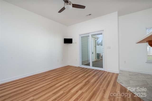 spare room featuring ceiling fan and light hardwood / wood-style floors